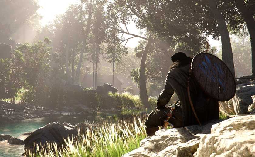 The main character from Crimson Desert sat on a rock and looking at a river.